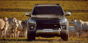 Chevrolet S10 de frente em ambiente rural, cercada por bois em meio ao campo.