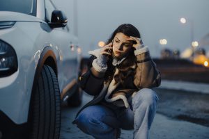 Woman with phone is calling in service of car