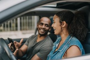 Couple planning road trip on smartphone
