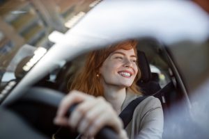 beautiful-young-woman-driving-her-new-car-at-sunset-woman-in-car-close-up-portrait-of-pleasant-looking-female-with-glad-positive-expression-woman-in-casual-wear-driving-a-car
