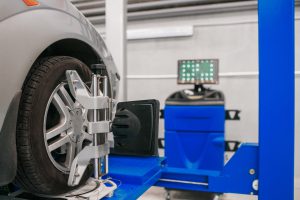 car-on-stand-with-sensors-wheels-for-alignment-camber-check-in-workshop-of-service-station