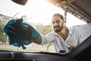 young-man-washing-windshield