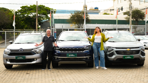 Emílio e Camila Camanzi com os braços abertos e entre os carros de 7 (sete) lugares: Spin, Aircross e Commander
