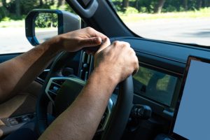 menshandsholdthesteeringwheelofacar