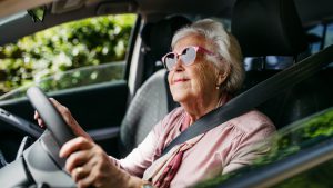 happyseniorwomandrivingcaraloneenjoyingcarride-safe
