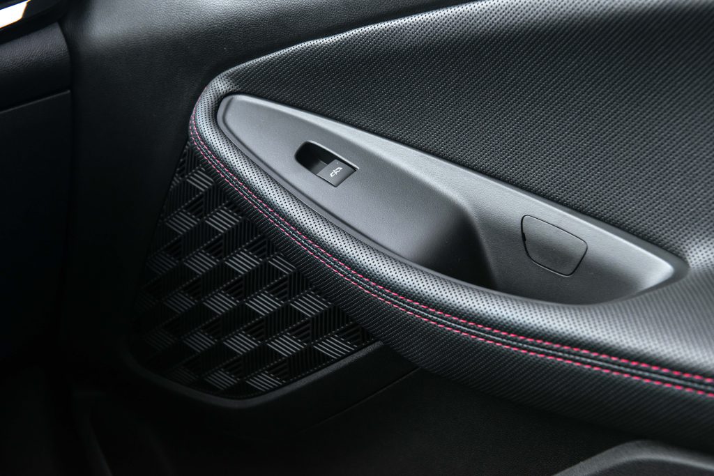 Interior da Chevrolet Montana, detalhe da porta com acabamento e controles de vidro elétrico.