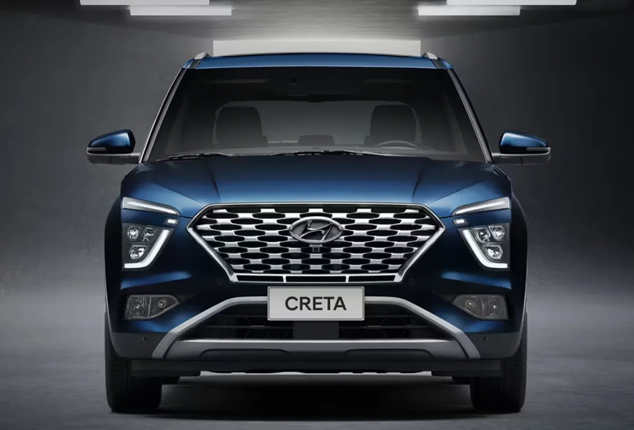 Hyundai Creta azul visto de frente em ambiente externo, destacando grade ampla, faróis de LED e design robusto do SUV compacto.