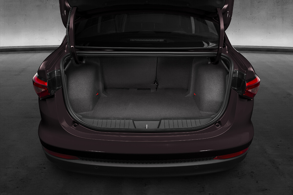 Porta-malas aberto de um Fiat Cronos, mostrando espaço interno amplo e capacidade para várias malas.