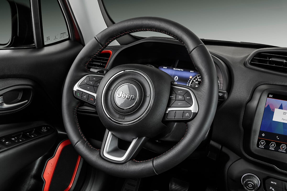 Volante do Jeep Renegade com acabamento em couro, comandos multifuncionais e logo central da Jeep.