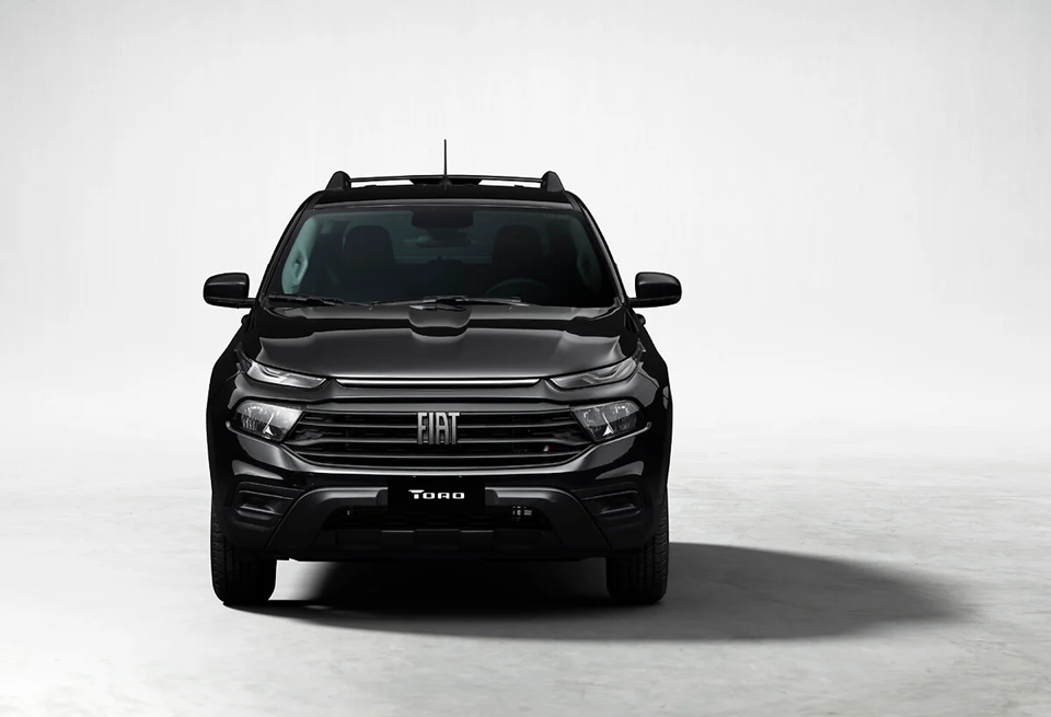 Fiat Toro preta vista de frente, destacando a grade robusta, os faróis em LED e o design imponente da picape.