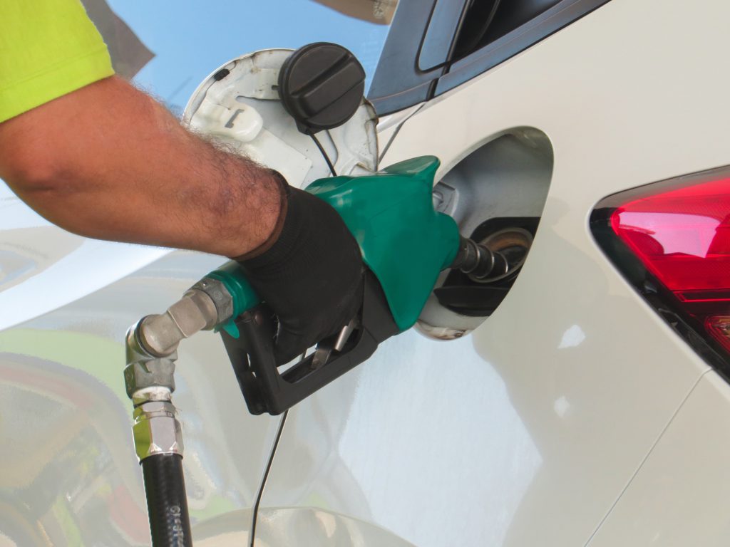 Employee filling the vehicle with Ethanol fuel.