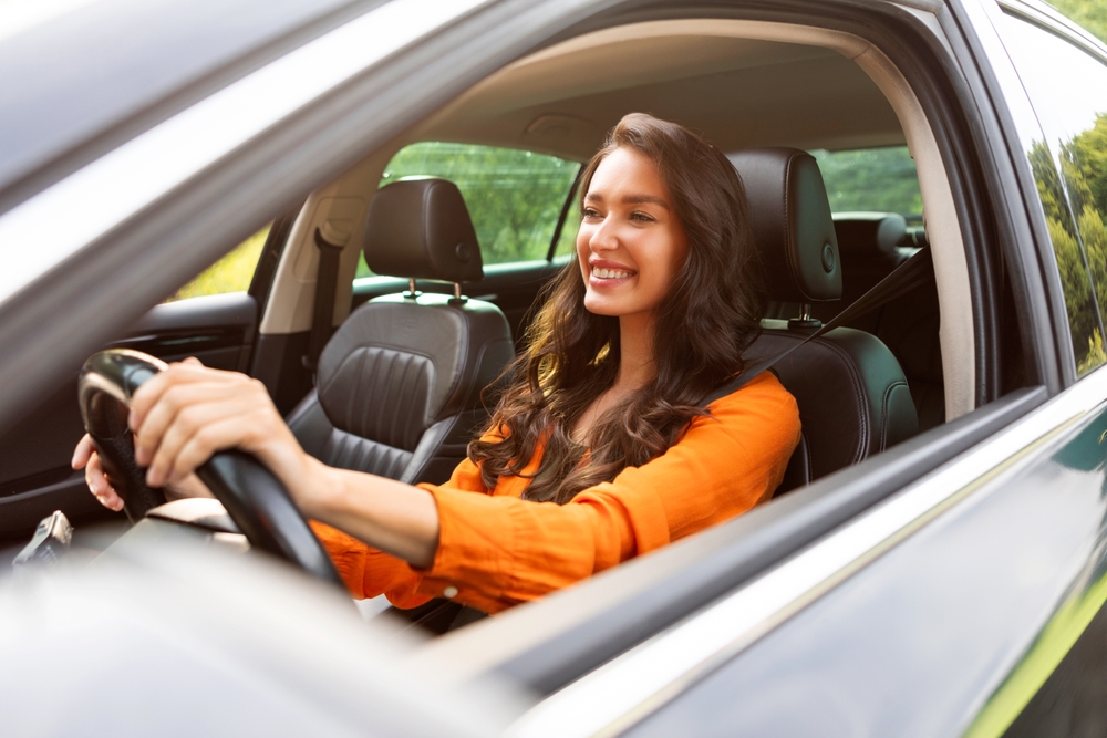 Happy,Young,Woman,Driving,Car,And,Smiling,,Enjoying,Automobile,Travel,